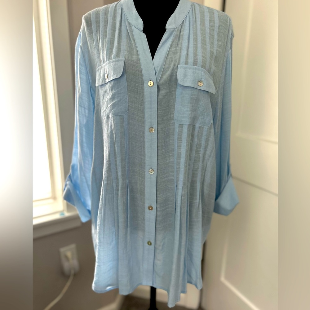 Blue blouse with pintuck details and front buttons. 3/4 length sleeves.
